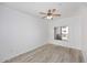 Bright bedroom featuring wood-look floors, ceiling fan and natural light from a window with white shutters at 5350 E Deer Valley Dr # 2435, Phoenix, AZ 85054