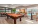 Billiards room with pool table, bar seating, and views of the community pool area at 5350 E Deer Valley Dr # 2435, Phoenix, AZ 85054