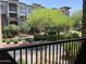 Apartment building view with landscaped grounds seen from a private balcony with black metal railings at 5350 E Deer Valley Dr # 2435, Phoenix, AZ 85054