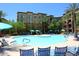 Resort-style pool with lounge chairs and umbrellas, set against the backdrop of the residential buildings at 5350 E Deer Valley Dr # 2435, Phoenix, AZ 85054
