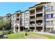 Exterior view of building with stone accents, landscaping and balconies at 5350 E Deer Valley Dr # 2435, Phoenix, AZ 85054