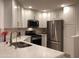 Well-lit kitchen with white cabinetry, stainless steel appliances, and granite countertops at 5350 E Deer Valley Dr # 2435, Phoenix, AZ 85054