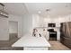 Open kitchen view with stainless steel appliances and countertops, connecting to another room at 5350 E Deer Valley Dr # 2435, Phoenix, AZ 85054