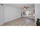 Bright living room with wood-look flooring, a ceiling fan, and windows with white shutters at 5350 E Deer Valley Dr # 2435, Phoenix, AZ 85054