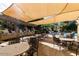 Community outdoor kitchen with multiple grills, tables, and seating by the pool at 5350 E Deer Valley Dr # 2435, Phoenix, AZ 85054