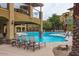 Scenic pool view featuring lounge seating, landscaping, and community building at 5350 E Deer Valley Dr # 2435, Phoenix, AZ 85054