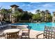 Community pool featuring mature trees, lounge seating, and ample sunshine at 5350 E Deer Valley Dr # 2435, Phoenix, AZ 85054