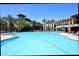 Stunning pool surrounded by palm trees, lounge chairs, and umbrellas at 5350 E Deer Valley Dr # 2435, Phoenix, AZ 85054