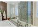 Modern bathroom featuring a soaking tub and a walk-in glass shower with designer tile at 5527 E Arroyo Verde Dr, Paradise Valley, AZ 85253