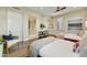 Comfortable bedroom with two beds, wood floors, a sitting chair, and access to a bathroom at 5527 E Arroyo Verde Dr, Paradise Valley, AZ 85253
