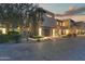 Beautiful desert home exterior showcasing a private drive and well-kept landscaping at sunset at 5527 E Arroyo Verde Dr, Paradise Valley, AZ 85253