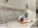Close-up of the kitchen counter, featuring mosaic backsplash and decor at 5527 E Arroyo Verde Dr, Paradise Valley, AZ 85253
