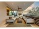 Covered patio with comfortable seating, fireplace, and stunning views at 5527 E Arroyo Verde Dr, Paradise Valley, AZ 85253