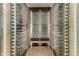 Modern wine cellar with glass enclosure, custom shelving, and space for seating and wine storage at 5527 E Arroyo Verde Dr, Paradise Valley, AZ 85253