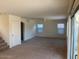 Spacious living room area featuring plush carpeting, neutral walls, and sunlit windows at 56 W Holstein Trl, San Tan Valley, AZ 85143