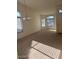 Large living room with lots of light coming in through the windows at 56 W Holstein Trl, San Tan Valley, AZ 85143