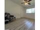 Bedroom features wood floors, window, ceiling fan, and a light-colored door at 601 W 15Th St, Tempe, AZ 85281