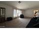 Bright living room with carpet, and furniture, featuring sheer curtains and natural light at 601 W 15Th St, Tempe, AZ 85281