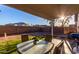 Landscaped backyard with table, grass, and a stone fence at 6331 W Winslow Ave, Phoenix, AZ 85043