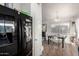 Open dining area with wood floors, neutral walls, and views to the kitchen and backyard at 6331 W Winslow Ave, Phoenix, AZ 85043