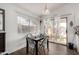 Bright dining area featuring wood floors, a modern light fixture, and sliding doors to the backyard patio at 6331 W Winslow Ave, Phoenix, AZ 85043