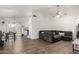Open-concept living room with wood-look flooring, ceiling fan, and dining area at 6331 W Winslow Ave, Phoenix, AZ 85043
