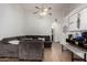 Cozy living room boasts wood-look flooring, ceiling fan, and archway detail at 6331 W Winslow Ave, Phoenix, AZ 85043