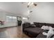Cozy living room with wood-look flooring, ceiling fan, and natural light at 6331 W Winslow Ave, Phoenix, AZ 85043