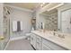 Bathroom with double sinks, tile flooring, and a shower with glass door and gray patterned towels at 6730 E Hermosa Vista Dr # 38, Mesa, AZ 85215