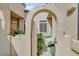 Charming courtyard entrance featuring arched gate and lush landscaping at 6730 E Hermosa Vista Dr # 38, Mesa, AZ 85215