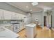 Bright kitchen featuring white cabinets, a center island, and skylight at 6730 E Hermosa Vista Dr # 38, Mesa, AZ 85215