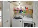 Efficient laundry room with a modern washer and dryer, storage shelves, and a glimpse of the outdoor patio at 6730 E Hermosa Vista Dr # 38, Mesa, AZ 85215