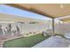 A tranquil enclosed patio boasts gravel ground cover and a synthetic grass patch at 6730 E Hermosa Vista Dr # 38, Mesa, AZ 85215