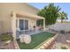 Cozy covered patio with an artificial grass area and landscaping at 6730 E Hermosa Vista Dr # 38, Mesa, AZ 85215