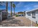 Large backyard with gravel landscaping, shed, seating area, and rear house view at 6801 E Sheena Dr, Scottsdale, AZ 85254