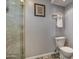 Modern bathroom with a toilet and a framed picture on the neutral colored wall at 6801 E Sheena Dr, Scottsdale, AZ 85254