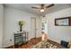 Cozy bedroom with a modern ceiling fan, wood floors, and an open doorway to another bedroom at 6801 E Sheena Dr, Scottsdale, AZ 85254