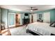 Large bedroom with wood floors, ceiling fan, and ensuite bathroom access through a sliding barn door at 6801 E Sheena Dr, Scottsdale, AZ 85254