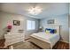 Bright bedroom featuring a white bed frame, white dresser, and a modern light fixture at 6801 E Sheena Dr, Scottsdale, AZ 85254