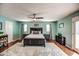 Spacious bedroom featuring wood floors, a ceiling fan, and a large patterned rug at 6801 E Sheena Dr, Scottsdale, AZ 85254