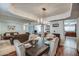Charming dining room adjacent to a living area features an elegant chandelier and hardwood floors at 6801 E Sheena Dr, Scottsdale, AZ 85254