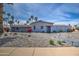Charming single-story home featuring a desert landscape, palm trees and a tile roof at 6801 E Sheena Dr, Scottsdale, AZ 85254