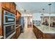 Contemporary kitchen featuring stainless appliances, tile backsplash, and granite countertops with breakfast bar seating at 6801 E Sheena Dr, Scottsdale, AZ 85254