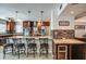 Inviting kitchen with stainless steel appliances, tile backsplash, and a large granite island with bar seating at 6801 E Sheena Dr, Scottsdale, AZ 85254
