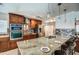 Beautiful kitchen features stainless steel appliances, tile backsplash, and granite island with bar seating at 6801 E Sheena Dr, Scottsdale, AZ 85254