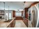 Spacious kitchen with stainless steel refrigerator, double ovens, granite countertops, and light colored floors at 6801 E Sheena Dr, Scottsdale, AZ 85254