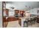 Stunning kitchen with wood cabinets, granite countertops, stainless steel appliances and bar stool seating at 6801 E Sheena Dr, Scottsdale, AZ 85254