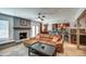 Inviting living room features a brick fireplace and an open layout into an updated kitchen at 6801 E Sheena Dr, Scottsdale, AZ 85254
