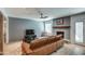 Modern living room with a painted brick accent wall, fireplace, and stylish furnishings at 6801 E Sheena Dr, Scottsdale, AZ 85254