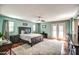 Spacious main bedroom featuring wood floors, a ceiling fan, and private access to the backyard at 6801 E Sheena Dr, Scottsdale, AZ 85254